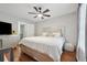 Bright main bedroom with a ceiling fan, window and hardwood floors at 6420 Marbut Rd, Lithonia, GA 30058