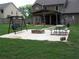 Spacious backyard features a patio, fire pit, swing, and green lawn at 70 Paladin Dr, Covington, GA 30016