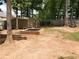 Backyard with brick fire pit, two storage sheds, and a swing at 70 Paladin Dr, Covington, GA 30016