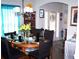 Formal dining room with stylish lighting, dark chairs, and a wood table set for a meal at 70 Paladin Dr, Covington, GA 30016