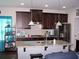 Well-equipped kitchen features dark cabinets, granite countertops, and stainless steel appliances at 70 Paladin Dr, Covington, GA 30016