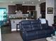 Open concept living room view into the kitchen with an island and stainless steel appliances at 70 Paladin Dr, Covington, GA 30016
