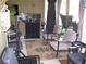 Screened-in porch with comfortable seating, floral rug, and a sound system entertainment setup at 70 Paladin Dr, Covington, GA 30016