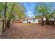View of the spacious backyard with a wooden fence and mature trees that provide plenty of shade at 1056 Park West Ct, Stone Mountain, GA 30088