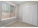 Bright bedroom features a large window and a closet with louvered doors offering a serene retreat at 1056 Park West Ct, Stone Mountain, GA 30088
