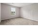 Bedroom with carpeted floors, closet, and window with natural light creating a tranquil space at 1056 Park West Ct, Stone Mountain, GA 30088