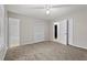 Cozy bedroom with carpeted floors, ceiling fan and natural light, adjacent to the bathroom at 1056 Park West Ct, Stone Mountain, GA 30088