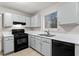 Well-lit kitchen with black appliances, neutral cabinets and countertop at 1056 Park West Ct, Stone Mountain, GA 30088