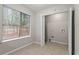 Convenient laundry area inside closet features tile floors, window, and washer/dryer hookups for ease at 1056 Park West Ct, Stone Mountain, GA 30088