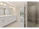 Bathroom with double vanity, framed mirror, and tiled shower with glass door at 1991 Deco Dr, Kennesaw, GA 30144