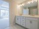 Bright bathroom features a double vanity with white cabinets, stone countertop and modern fixtures at 1991 Deco Dr, Kennesaw, GA 30144