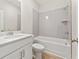 Bathroom featuring a tub with tiled shower, white fixtures, and storage at 1991 Deco Dr, Kennesaw, GA 30144