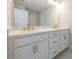 Bright bathroom with a double sink vanity, white cabinets, and large mirror at 1991 Deco Dr, Kennesaw, GA 30144