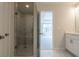 Bathroom showcasing a glass-enclosed shower with marble tile and modern vanity with white cabinets at 1991 Deco Dr, Kennesaw, GA 30144