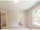Bedroom with plush carpeting, large window, and bathroom access at 1991 Deco Dr, Kennesaw, GA 30144