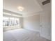 Cozy bedroom with carpet, a tray ceiling, and a large window overlooking neighboring townhouses at 1991 Deco Dr, Kennesaw, GA 30144