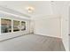 Bright bedroom with plush carpeting, tray ceiling, and large window offering a neighborhood view at 1991 Deco Dr, Kennesaw, GA 30144