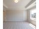 Bedroom with plush carpeting, bright window, and tray ceiling, showcasing neutral color palette at 1991 Deco Dr, Kennesaw, GA 30144