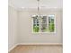 Bright dining room with large window and modern chandelier at 1991 Deco Dr, Kennesaw, GA 30144