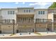 Townhome exteriors feature individual garages and covered decks with wood railings at 1991 Deco Dr, Kennesaw, GA 30144