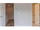 Hallway with multiple doors, leading to rooms with warm-toned walls and laminate floors at 1991 Deco Dr, Kennesaw, GA 30144