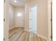 Bright hallway featuring durable hardwood floors and access to the front door and other rooms in the home at 1991 Deco Dr, Kennesaw, GA 30144
