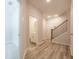 Hallway features wood-look flooring, a staircase with dark railings, and doorways to other rooms at 1991 Deco Dr, Kennesaw, GA 30144