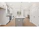 Kitchen features white cabinets and a large island with quartz countertops and stainless appliances at 1991 Deco Dr, Kennesaw, GA 30144