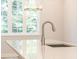 Bright kitchen with stainless steel faucet, countertop, and window at 1991 Deco Dr, Kennesaw, GA 30144