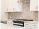 Close up of kitchen with stainless steel oven and white cabinets at 1991 Deco Dr, Kennesaw, GA 30144
