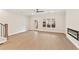 Open living room with wood floors, modern fireplace, ceiling fan and lots of natural light at 1991 Deco Dr, Kennesaw, GA 30144