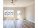 Bright living room with ceiling fan, laminate flooring, window, and glass door at 1991 Deco Dr, Kennesaw, GA 30144