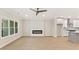 Open-concept living room with fireplace and seamless flow into the modern kitchen at 1991 Deco Dr, Kennesaw, GA 30144