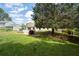 Expansive backyard showcasing a large tree, providing ample shade and a serene outdoor space at 217 Colemans Bluff Dr, Woodstock, GA 30188