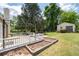 Large backyard with a deck, garden beds, lawn and a storage shed at 217 Colemans Bluff Dr, Woodstock, GA 30188