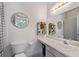 Bathroom with a white sink, vanity, and a decorative mirror at 217 Colemans Bluff Dr, Woodstock, GA 30188