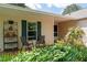Inviting front porch with seating and lush landscaping, offering a cozy outdoor space at 217 Colemans Bluff Dr, Woodstock, GA 30188