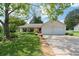 Charming single-story home with a manicured lawn, mature trees, and an attached two-car garage at 217 Colemans Bluff Dr, Woodstock, GA 30188