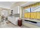 Bright kitchen with white cabinetry, tiled flooring, and a window with outside view at 217 Colemans Bluff Dr, Woodstock, GA 30188