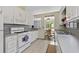 Kitchen with white appliances, ample counter space, and a view to the backyard at 217 Colemans Bluff Dr, Woodstock, GA 30188