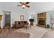 Comfortable living room with a stone fireplace, ceiling fan, and wood-look flooring at 217 Colemans Bluff Dr, Woodstock, GA 30188