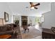 Spacious living room featuring a stone fireplace, ceiling fan, and wood-look floors at 217 Colemans Bluff Dr, Woodstock, GA 30188