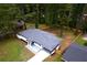 An aerial shot of this ranch style home and its large, treed lot with a gray roof at 2720 Cavalier Dr, Decatur, GA 30034