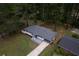 Bird's eye view of house with mature landscaping and fresh gray roof at 2720 Cavalier Dr, Decatur, GA 30034