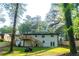 Spacious backyard featuring a deck with stairs and a lawn, all freshly landscaped at 2720 Cavalier Dr, Decatur, GA 30034