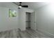 This bedroom features a ceiling fan, wood-look floors, neutral paint, a window and a closet with shelving at 2720 Cavalier Dr, Decatur, GA 30034