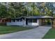 Charming one-story home with a covered carport, newly painted exterior, and a well-manicured lawn at 2720 Cavalier Dr, Decatur, GA 30034
