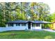 Charming, renovated ranch home with a crisp white exterior, dark trim, and covered front porch at 2720 Cavalier Dr, Decatur, GA 30034