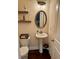 Stylish powder room featuring a pedestal sink, decorative mirror, and modern lighting fixtures at 5637 Valley Loop, Fairburn, GA 30213