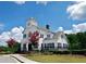 Exterior view of a lovely community clubhouse with a charming tower clock on a clear day at 5637 Valley Loop, Fairburn, GA 30213